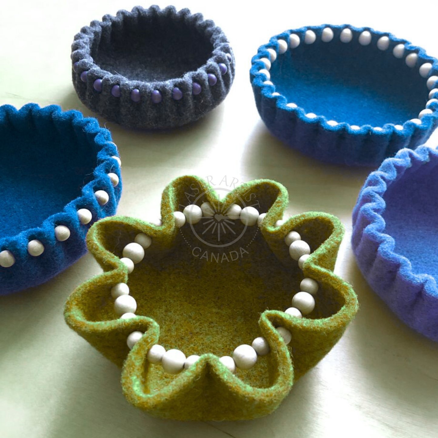Handmade felt bowls in autumn colours created during a cozy craft workshop
