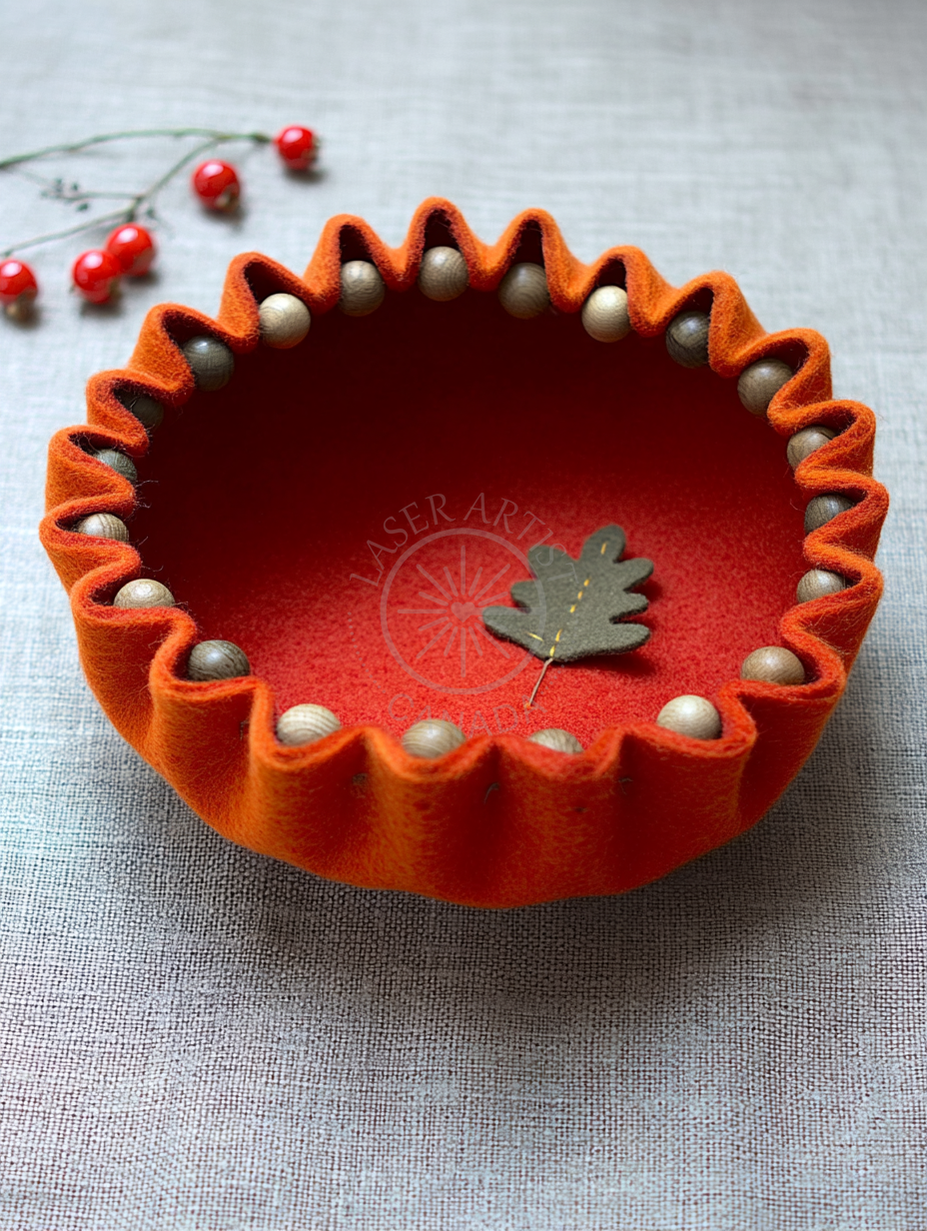 Hands stitching a sculpted felt bowl with needle and thread close up
